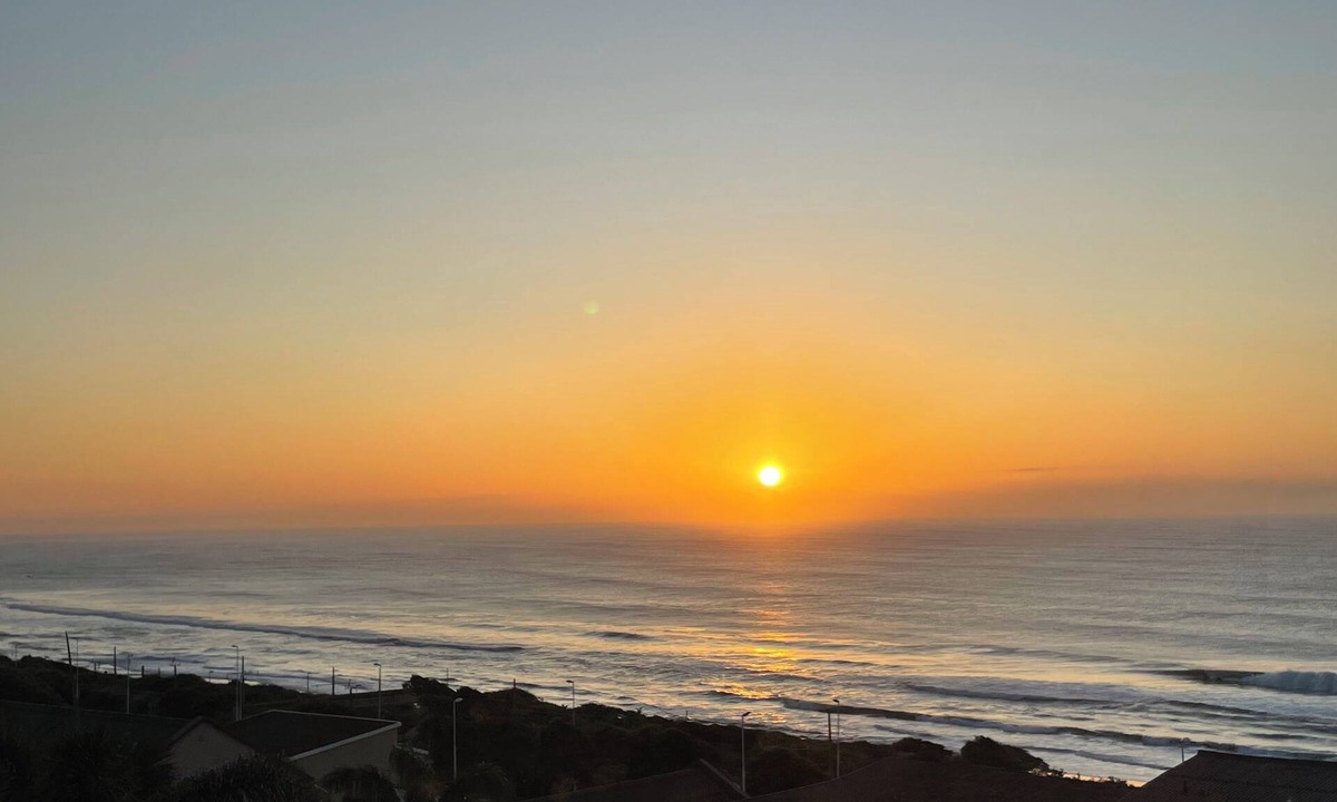 Warner Beach Cottage | Wake up to gorgeous sunrises and sea views upon a wooden balcony.