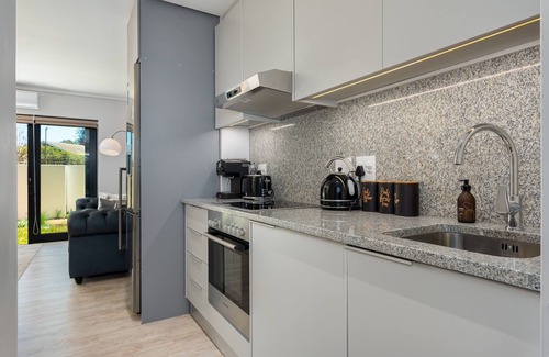 Milnerton Apartment | Elegant Seaside Village Apartment with Garden View