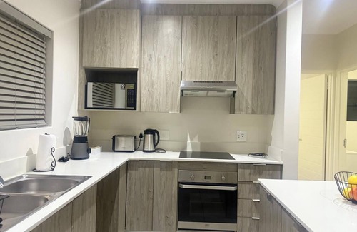 Greater Johannesburg Metropolitan Area Apartment | Sandton 2-Bed with Garden near Sandton City & Gautrain. For Business & Leisure.