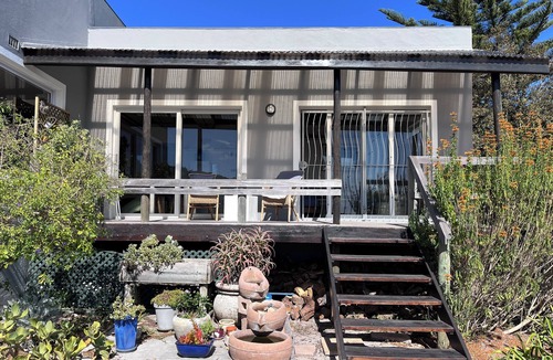 Kommetjie Apartment | Cozy Retreat: 1-Bedroom with stunning sea view down serene green belt."