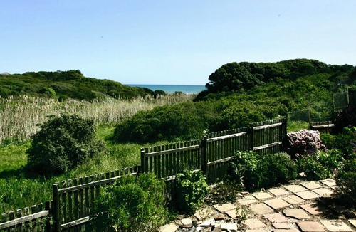 Kommetjie Apartment | Cozy Retreat: 1-Bedroom with stunning sea view down serene green belt."