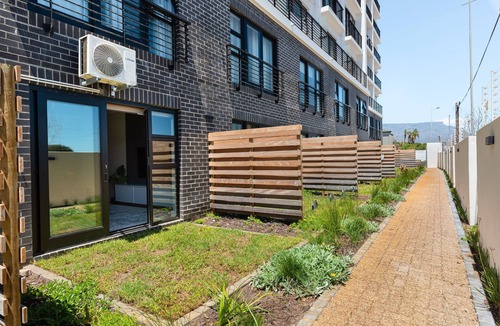 Milnerton Apartment | Elegant Seaside Village Apartment with Garden View