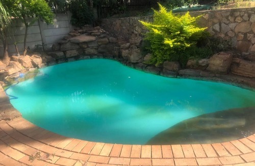 Randpark Ridge House | Lovely Studio Apartment sitting on a lovely acreage with natural man made rocks.