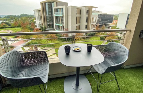 Menlyn Apartment | Menlyn Maine Residence King sized bed with patio - Paris