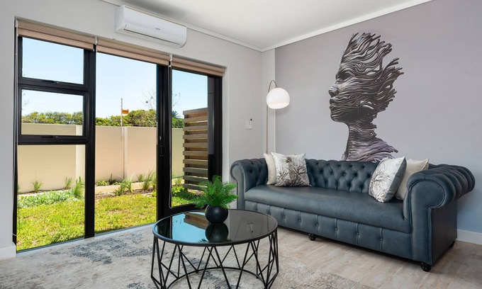 Milnerton Apartment | Elegant Seaside Village Apartment with Garden View