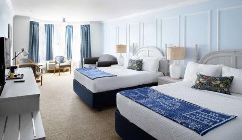 Two Queen Beds With A Couch